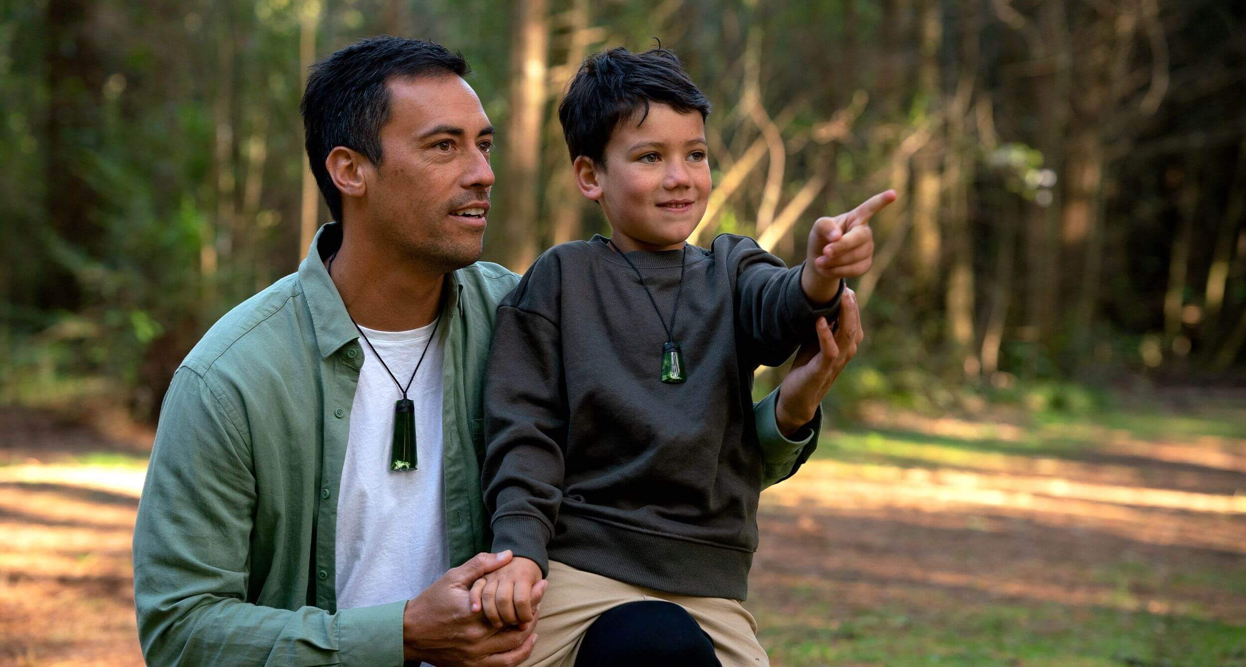Image of man and son, man is wearing toki piece