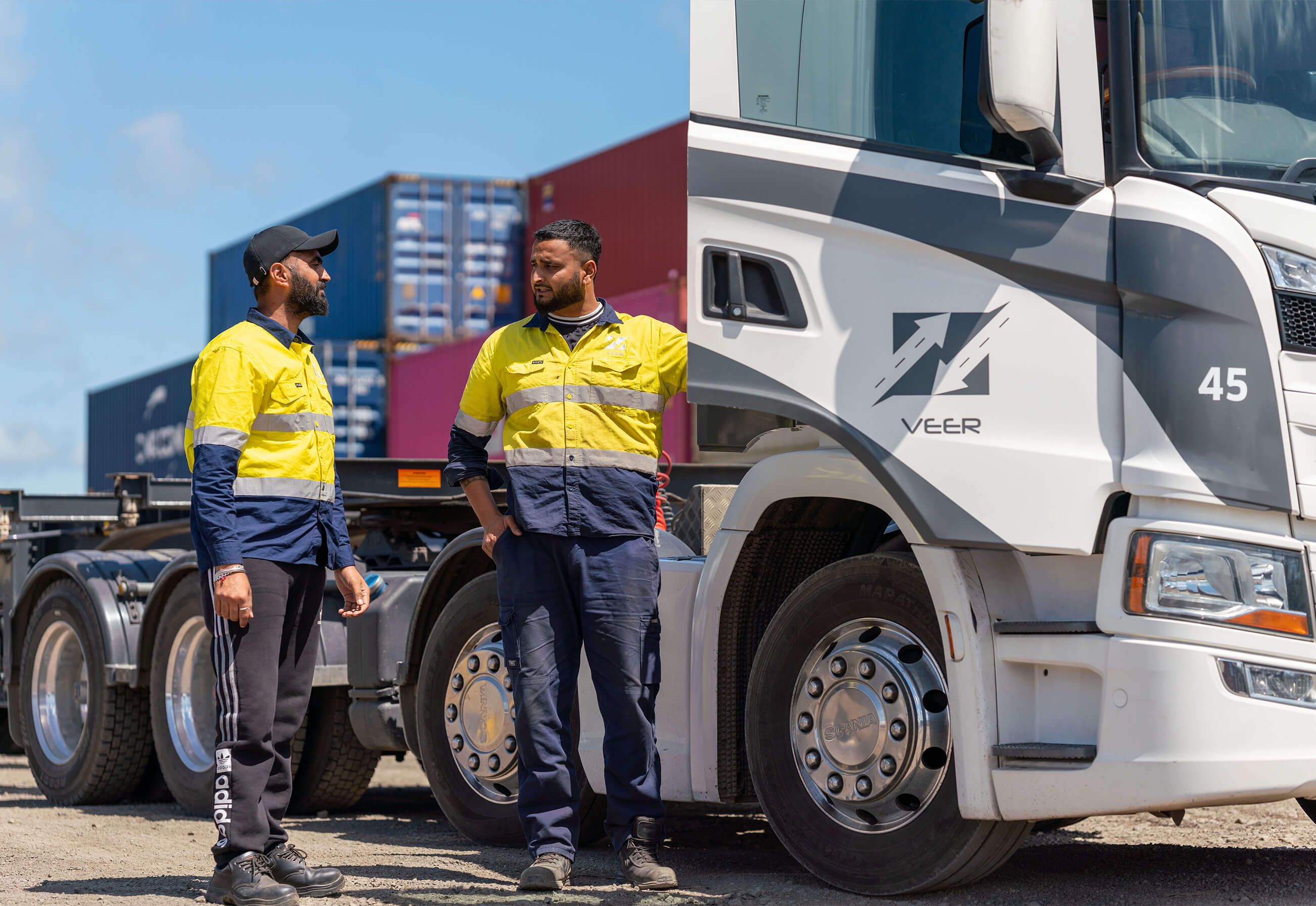 Two men standing next to truck
